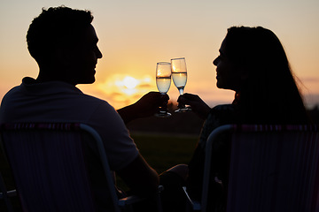 Image showing Couple, toast and sunset love of people silhouette with champagne glasses outdoor. Happy, alcohol and valentines day celebration in nature with cheers together on a date with happiness on anniversary