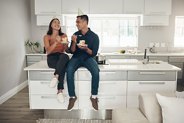 Image showing Couple, birthday cake and celebration in a home kitchen with happy people and food. Celebrate, table sitting and laughing of a woman and man together with love and care with dessert for party