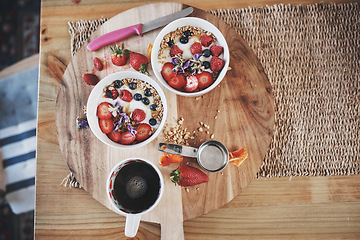 Image showing Healthy breakfast, cereal and diet above on table of fruit, wheat or oats for organic food, wellness or fiber nutrition at home. Bowls for brunch with cup of coffee for dieting plan on counter top