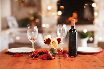 Image showing Romantic, dinner table and setup for valentines day, fine dining or date at indoor night restaurant. Interior diner with wine glasses prepared with roses and champagne for evening couple reservation