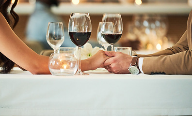 Image showing Love, wine and couple holding hands in restaurant for romantic dinner, date and anniversary celebration. Relationship, fine dining and man and woman together for luxury date, alcohol and honeymoon