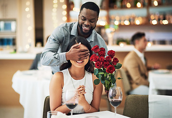 Image showing Rose surprise, couple and restaurant of people ready for fine dining with love and care. Flowers present, bouquet and date of a woman and man together with celebration on a table with a smile