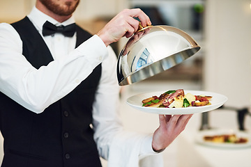 Image showing Waiter, hands and opening plate of food for serving, meal or customer service at indoor restaurant. Man employee caterer or server catering or bringing open dish for fine dining, hospitality or order