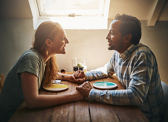 Image showing Love, couple and holding hands at home on table, talking and bonding together. Valentines day, romance diversity and affection of man and woman on date, having fun and enjoying quality time in house.