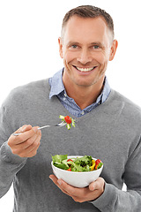 Image showing Salad, portrait and man isolated on a white background for healthy green food, diet and nutritionist breakfast. Professional person or model eating vegetables or food for vegan or nutrition in studio