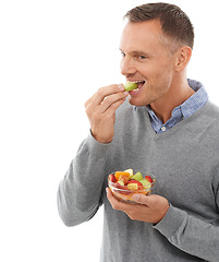 Image showing Mature man eating fruits isolated on a white background for healthy green lunch, diet choice or nutritionist breakfast. Professional vegan person or model with fruits salad, food or apple in studio