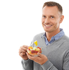 Image showing Portrait, studio and happy man eating fruit salad for healthy snack, diet meal or craving. Happiness, smile and male model enjoying fresh produce for health and wellness isolated by white background.