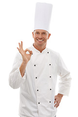 Image showing Portrait of chef, man with ok hand gesture and confident smile, cafe owner isolated on white background. Happy executive cook, uniform tasty emoji for restaurant discount deal or promotion in studio.