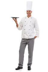 Image showing Portrait of chef holding empty tray, menu special and smile presenting promo deal or restaurant product placement. Happy full body cook man in uniform, mock up isolated on white background in studio.