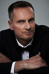 Image showing Studio portrait of mature man, tuxedo and handsome, serious and isolated on grey background. Luxury, glamour and wealth, success with celebrity actor style, elegant and sexy date for valentines day.