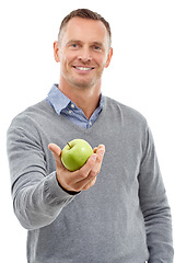 Image showing Giving apple, studio portrait and man with fruit for health, diet and wellness isolated on a white background. Model person with nutrition vegan food in hand for healthy lifestyle and clean eating