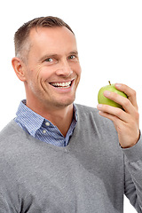 Image showing Man, eating apple and studio portrait with fruit for health, diet and wellness isolated on a white background. Model person with nutrition vegan food for healthy lifestyle, motivation and happy smile