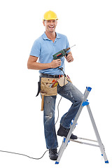 Image showing Portrait, construction and a DIY man in studio isolated on a white background with a ladder and drill. Building, design and industry with a male handyman using an electric tool for renovation