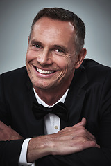 Image showing Happy, portrait and man in a tuxedo in studio for a luxury valentines day, anniversary or romantic date. Happiness, smile and mature male model or gentleman in elegant formal suit by gray background.