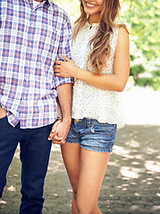 Image showing Couple, walking and arm holding in a park on outdoor path or road feeling love in summer. Nature, care and date with happiness, smile and sunshine holding hands together excited about romance