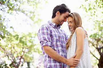 Image showing Love, nature and couple in park on valentines day with trees celebrating romantic outdoor forest date. Romance, relationship and man with woman in garden together with happy smile and loving touch.