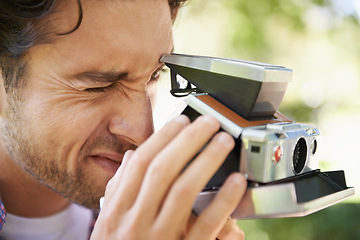 Image showing Photography, shooting and man with a vintage camera in nature for a photo and hobby in France. Creative, artistic and zoom on a photographer taking pictures in a park for film and recreation