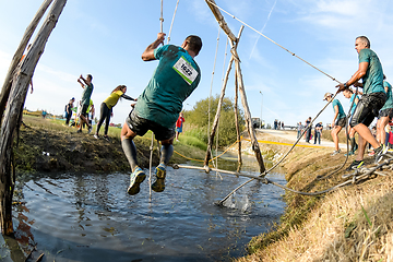 Image showing Athletes go through mud and water