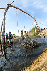 Image showing Athletes go through mud and water