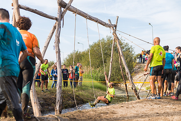 Image showing Athletes go through mud and water