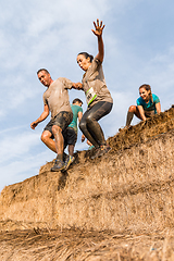 Image showing Athletes overcoming the hay osbtacle