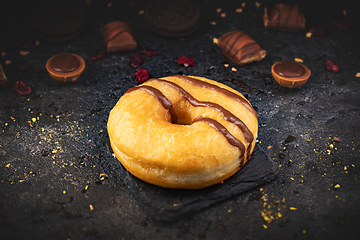 Image showing Delicious donut on black slate background