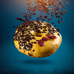 Image showing Flying donut in yellow glaze