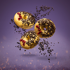 Image showing Flying donuts with sprinkles