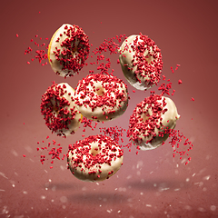 Image showing Flying donuts glazed with white chocolate