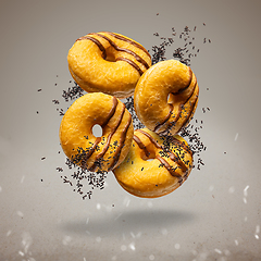 Image showing Flying delicious classic donuts