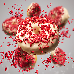 Image showing Flying donuts glazed with white chocolate