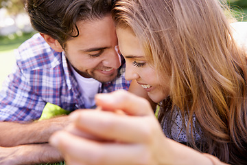 Image showing Happy couple, bonding or love date on grass, nature park or garden on valentines day, romance or anniversary celebration. Smile, woman or man in relax environment, summer break or partnership picnic