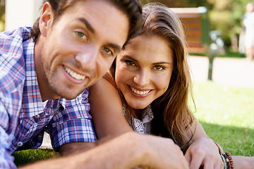 Image showing Happy couple, portrait or love date on grass, nature park or garden bonding on valentines day, romance or anniversary celebration. Smile, woman or man lying in relax environment or partnership picnic