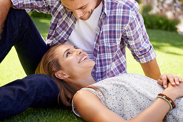 Image showing Bonding couple, lying and love on grass, nature park or garden on valentines day, romance date or marriage bonding. Smile, happy woman and man in relax environment, summer rest or partnership picnic