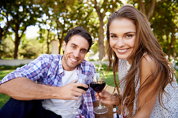Image showing Couple portrait, wine or love toast on picnic date, valentines day or romance bonding in nature park or garden. Smile, happy woman or man and alcohol drinks glass for marriage anniversary celebration