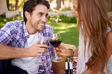 Image showing Happy couple, love and wine toast for picnic, valentines day or romance date bonding in nature park or garden grass. Smile, woman and man and alcohol drinks glass in marriage anniversary celebration