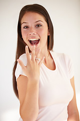 Image showing Portrait of woman excited with ring for engagement, marriage and wedding on white background. Love, wow and happy girl show diamond jewellery on hand for romance celebration, commitment and proposal