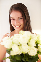 Image showing Portrait, woman and bouquet of flowers for celebration, happiness and achievement with smile, gift or beauty. Face, confident female or happy lady with white roses, floral present or romantic gesture