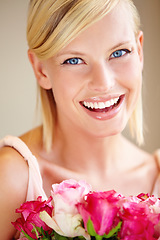 Image showing Flowers, portrait and happy woman in a studio with roses for valentines day, anniversary or romantic event. Happiness, smile and female from canada with a pink floral bouquet by a nude background.