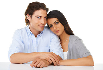 Image showing Portrait, love and couple together in a studio with white background and hand holding. Sitting, studio and smile of a young man and woman from Israel in marriage with casual fashion and connection