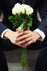 Image showing Hands, flowers and man on wedding day waiting for ceremony of love, tradition or romance closeup. Floral bouquet, marriage and commitment with a groom sitting outdoor alone at a celebration event