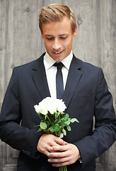 Image showing Love, man and bunch of white roses, smile and gift for date, relationship and guy with joy. Romance, male and gentleman with suit, plants or flowers for wedding, happiness or celebration with bouquet