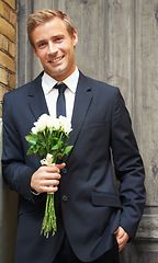 Image showing Rose, portrait and man with gift for valentines day, anniversary or first date while waiting on door background. Face, flowers and gentleman with sweet, gesture or offering for love and romance