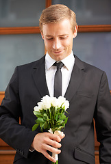 Image showing Love, romantic and man with flowers for valentines day, romance or gesture while standing against a wall background. Roses, happy and gentleman with bouquet for sweet, anniversary gift or first date