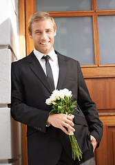 Image showing Love, portrait and man with flowers for valentines day, romance or gesture while standing against a wall background. Roses, happy and gentleman with bouquet for sweet, anniversary gift or first date