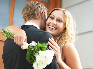 Image showing Couple, hug and flowers for love, valentines day or date embracing relationship in the outdoors together. Happy woman hugging boyfriend holding white roses or bouquet to celebrate the special month