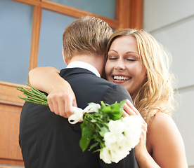 Image showing Couple, flowers and hug with smile for valentines day embrace or relationship celebration for date. Happy woman hugging man and holding white roses or bouquet to celebrate the special month of love