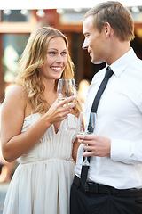 Image showing Wine, love and couple at a party, smile and happy while talking, flirting and bonding at an outdoor event. Champagne, romance and man with woman in romantic moment, first date or valentines day