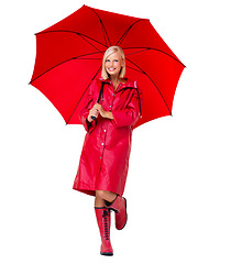 Image showing Portrait woman and umbrella with smile, cover and confident girl isolated on white studio background. Face, young female and happy lady with cover from rain, joyful and cheerful with jacket and boots