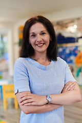 Image showing Portrait of a teacher in a preschool institution, in the background of the classrooms